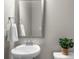 Bathroom featuring a pedestal sink, a mirror and a plant on the toilet at 1381 Wallace Walk, Atlanta, GA 30316