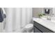 Bathroom featuring a white shower curtain and a vanity with light countertop and gray cabinets at 1381 Wallace Walk, Atlanta, GA 30316