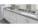 Bathroom featuring double sink vanity with gray granite countertop and white cabinets at 1381 Wallace Walk, Atlanta, GA 30316