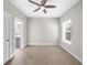 Bedroom featuring a ceiling fan, window with blinds, and door to a bathroom at 1381 Wallace Walk, Atlanta, GA 30316
