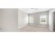 Minimalist bedroom with neutral carpet, two windows and white walls at 1381 Wallace Walk, Atlanta, GA 30316