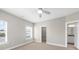 Bright bedroom featuring a ceiling fan, window with blinds, and doorway to closet at 1381 Wallace Walk, Atlanta, GA 30316