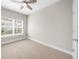 Neutral bedroom featuring a ceiling fan, window with blinds, and neutral carpet at 1381 Wallace Walk, Atlanta, GA 30316