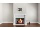 Close-up of a modern fireplace with white tile surround and hardwood floors at 1381 Wallace Walk, Atlanta, GA 30316