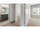 Hallway with open doors to a bathroom, bedroom, and window at 1381 Wallace Walk, Atlanta, GA 30316