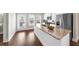 Bright kitchen with stainless appliances, granite countertops, and an island open to the balcony at 1381 Wallace Walk, Atlanta, GA 30316