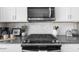 Modern kitchen featuring stainless steel appliances, white cabinets, and stylish backsplash for a sleek design at 1381 Wallace Walk, Atlanta, GA 30316