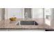 Spacious kitchen island featuring granite countertop and stainless sink, perfect for meal prep and dining at 1381 Wallace Walk, Atlanta, GA 30316