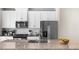 Modern kitchen featuring white cabinets, stainless steel appliances, and granite countertops for a stylish design at 1381 Wallace Walk, Atlanta, GA 30316