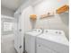 Laundry room featuring a washer, dryer, and storage shelf at 1381 Wallace Walk, Atlanta, GA 30316