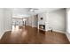 Living room featuring fireplace, hardwood floors, and open concept to kitchen at 1381 Wallace Walk, Atlanta, GA 30316