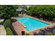 A refreshing community pool with lounge chairs surrounded by a brick patio and green foliage at 1381 Wallace Walk, Atlanta, GA 30316