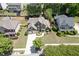 Lovely aerial view of a home with a well-kept lawn, surrounded by lush trees in a friendly neighborhood at 1563 Country Wood Dr, Hoschton, GA 30548