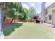 Lush backyard with green lawn, mature trees, a patio with furniture, and privacy fencing at 1563 Country Wood Dr, Hoschton, GA 30548