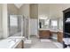 Bathroom featuring a soaking tub, walk-in shower with glass door, and a high ceiling at 1563 Country Wood Dr, Hoschton, GA 30548