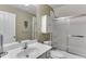 Bright bathroom featuring a white vanity, cabinet, toilet, shower and frosted glass shower door at 1563 Country Wood Dr, Hoschton, GA 30548