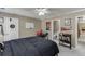 Comfortable bedroom with a full-sized bed, neutral carpet, and a well-lit study area at 1563 Country Wood Dr, Hoschton, GA 30548