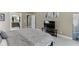 Large bedroom featuring carpeted floors, a TV, and access to the en suite bathroom at 1563 Country Wood Dr, Hoschton, GA 30548