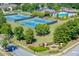 An aerial view of the community tennis courts, pool and amenity center for residents at 1563 Country Wood Dr, Hoschton, GA 30548
