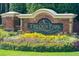 A welcoming brick entrance sign for Trilogy Park with colorful flowers and landscaping at 1563 Country Wood Dr, Hoschton, GA 30548