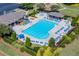 A community pool with many lounge chairs, a shelter, and beautiful landscaping surrounding the fence at 1563 Country Wood Dr, Hoschton, GA 30548