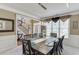 Formal dining room featuring a large window, stylish lighting, and views into the foyer and living room at 1563 Country Wood Dr, Hoschton, GA 30548