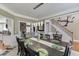 Open dining room with a long table set for dinner and views into the living room and foyer at 1563 Country Wood Dr, Hoschton, GA 30548