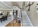 Inviting foyer featuring hardwood floors, a staircase with iron railings, and decorative wall art at 1563 Country Wood Dr, Hoschton, GA 30548