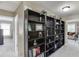 Hallway with large bookshelf featuring decorative items at 1563 Country Wood Dr, Hoschton, GA 30548
