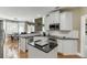 Kitchen featuring stainless steel appliances, granite counters, a kitchen island and an adjacent dining area at 1563 Country Wood Dr, Hoschton, GA 30548