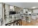Open kitchen and living room concept featuring granite countertops, modern appliances and fixtures at 1563 Country Wood Dr, Hoschton, GA 30548