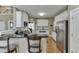 Kitchen featuring stainless steel appliances, white cabinets, granite counters and adjacent dining area at 1563 Country Wood Dr, Hoschton, GA 30548
