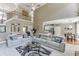 Open concept living room with high ceilings, comfortable sofas, and views of the dining area and kitchen at 1563 Country Wood Dr, Hoschton, GA 30548