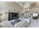 Open living room with soaring ceilings, large windows, staircase, and entertainment center at 1563 Country Wood Dr, Hoschton, GA 30548