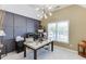 Office space featuring a modern light fixture, a desk with computer monitors, and carpeted floors at 1563 Country Wood Dr, Hoschton, GA 30548
