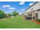 Spacious backyard with an outdoor kitchen/grilling area and stone landscaping at 2470 Day Break Way, Dacula, GA 30019