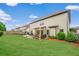 Large backyard with lush green grass, patio area, and well-maintained landscaping at 2470 Day Break Way, Dacula, GA 30019
