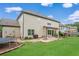 Large backyard featuring a trampoline, grilling area, and fire pit at 2470 Day Break Way, Dacula, GA 30019