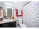 Cozy bathroom with a functional vanity, toilet, and shower featuring a colorful curtain at 2470 Day Break Way, Dacula, GA 30019