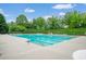 Sparkling community pool with ample seating and surrounded by mature trees providing a resort-like experience at 2470 Day Break Way, Dacula, GA 30019
