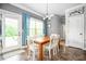 Traditional dining room with a wood table, white chairs, and tile floors near a glass door to the outside at 2470 Day Break Way, Dacula, GA 30019