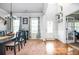 Open-concept dining room with views to the entry and French doors, and neutral colors at 2470 Day Break Way, Dacula, GA 30019