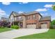 Charming two-story brick home with an attached three-car garage and fresh landscaping at 2470 Day Break Way, Dacula, GA 30019