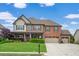 Lovely two-story brick home with a three-car garage and well-manicured lawn at 2470 Day Break Way, Dacula, GA 30019