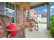 Relaxing front porch with rocking chairs and decorative touches overlooking green lawn at 2470 Day Break Way, Dacula, GA 30019