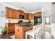 This kitchen features a large island, modern appliances, ample cabinet space and tiled flooring at 2470 Day Break Way, Dacula, GA 30019