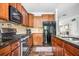 Modern kitchen featuring stainless steel appliances, granite counters, and wood cabinets at 2470 Day Break Way, Dacula, GA 30019
