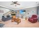 Inviting living area includes a TV, neutral walls, and carpeted floor at 2470 Day Break Way, Dacula, GA 30019