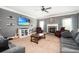 Cozy living room featuring a fireplace, mounted TV, and comfortable seating arrangement at 2470 Day Break Way, Dacula, GA 30019