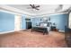 Main bedroom featuring light blue walls, ample natural light, and dark furniture at 2470 Day Break Way, Dacula, GA 30019